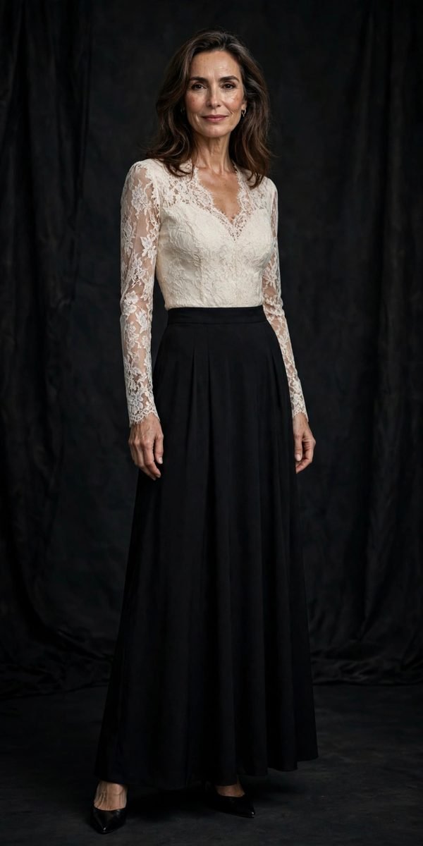 Woman over 40 in an ivory lace top with a long black skirt