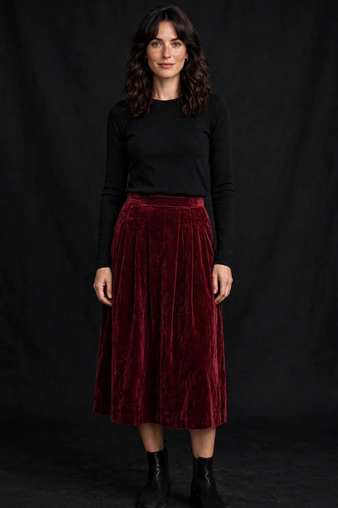 Woman in a thrifted velvet skirt with a plain black top