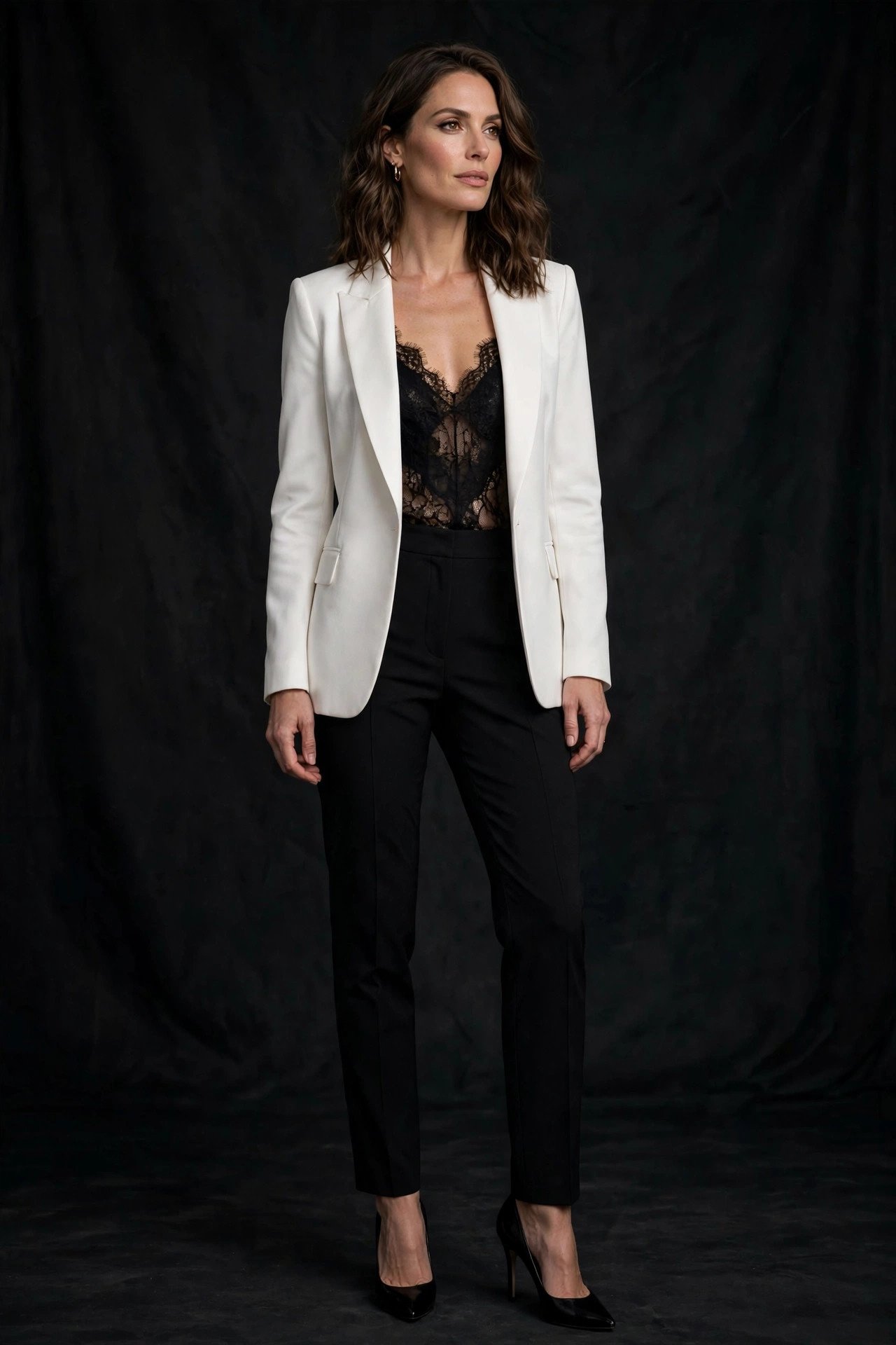 woman in white tailored blazer over black lace cami