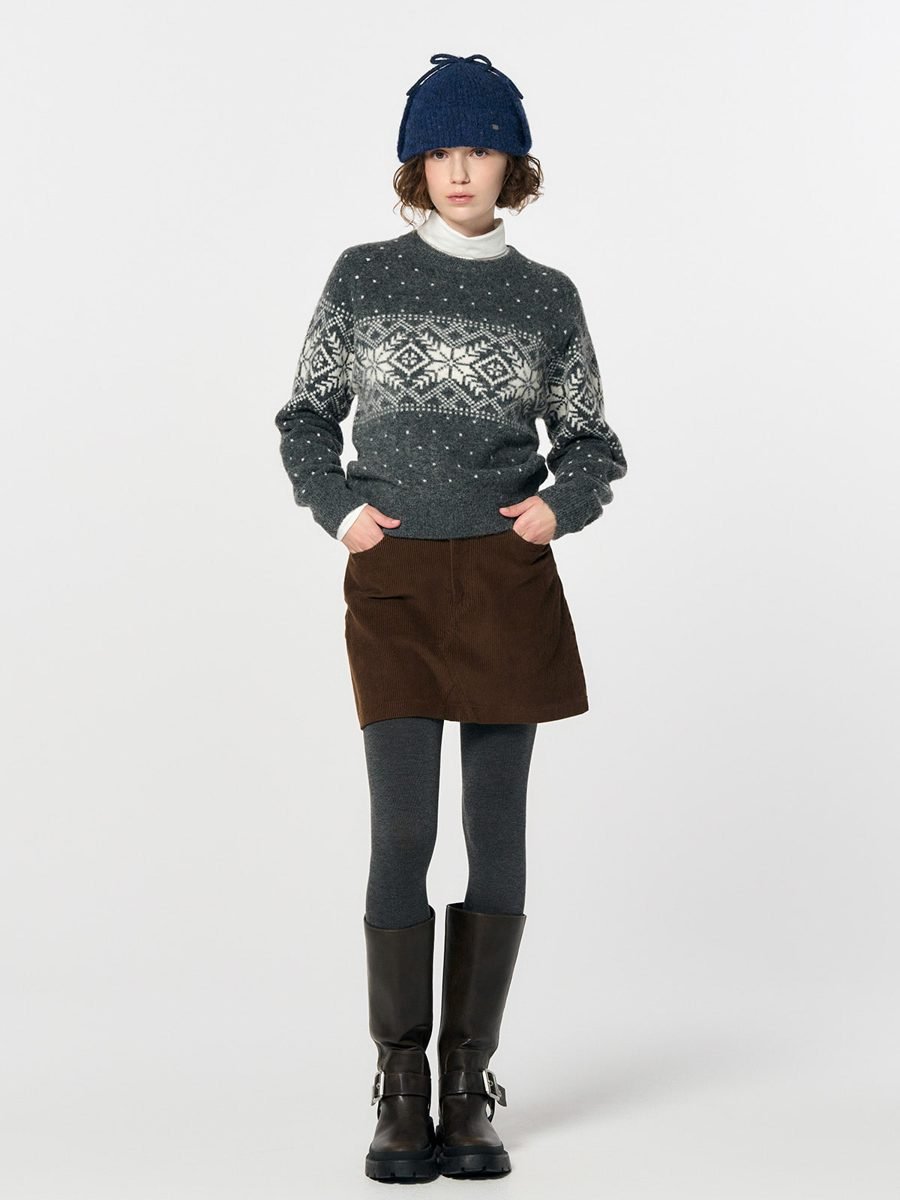 woman in fair isle sweater and corduroy mini skirt with knee-high boots
