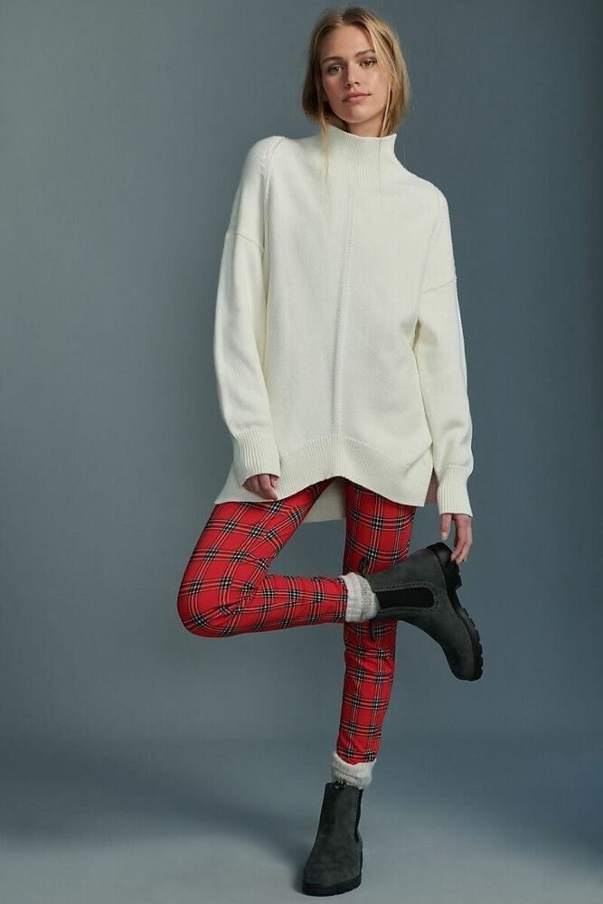 woman in red plaid trousers and cream sweater with brown ankle boots