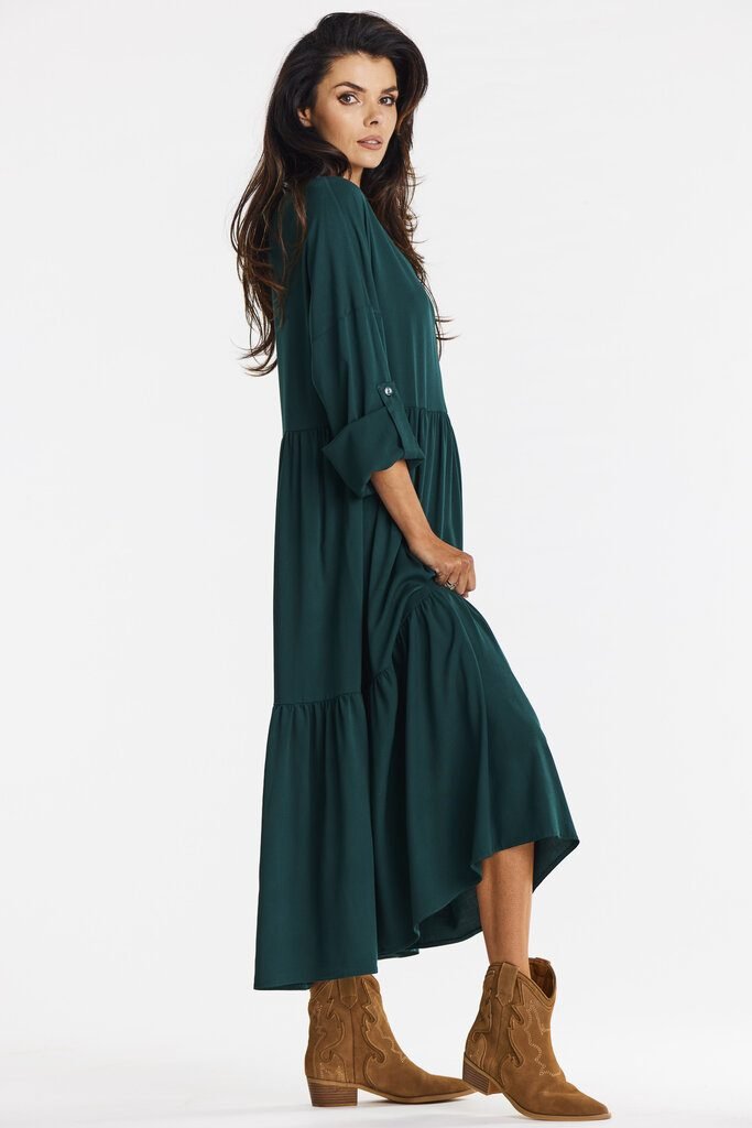 woman in forest green midi dress with tan heeled boots at a holiday lunch
